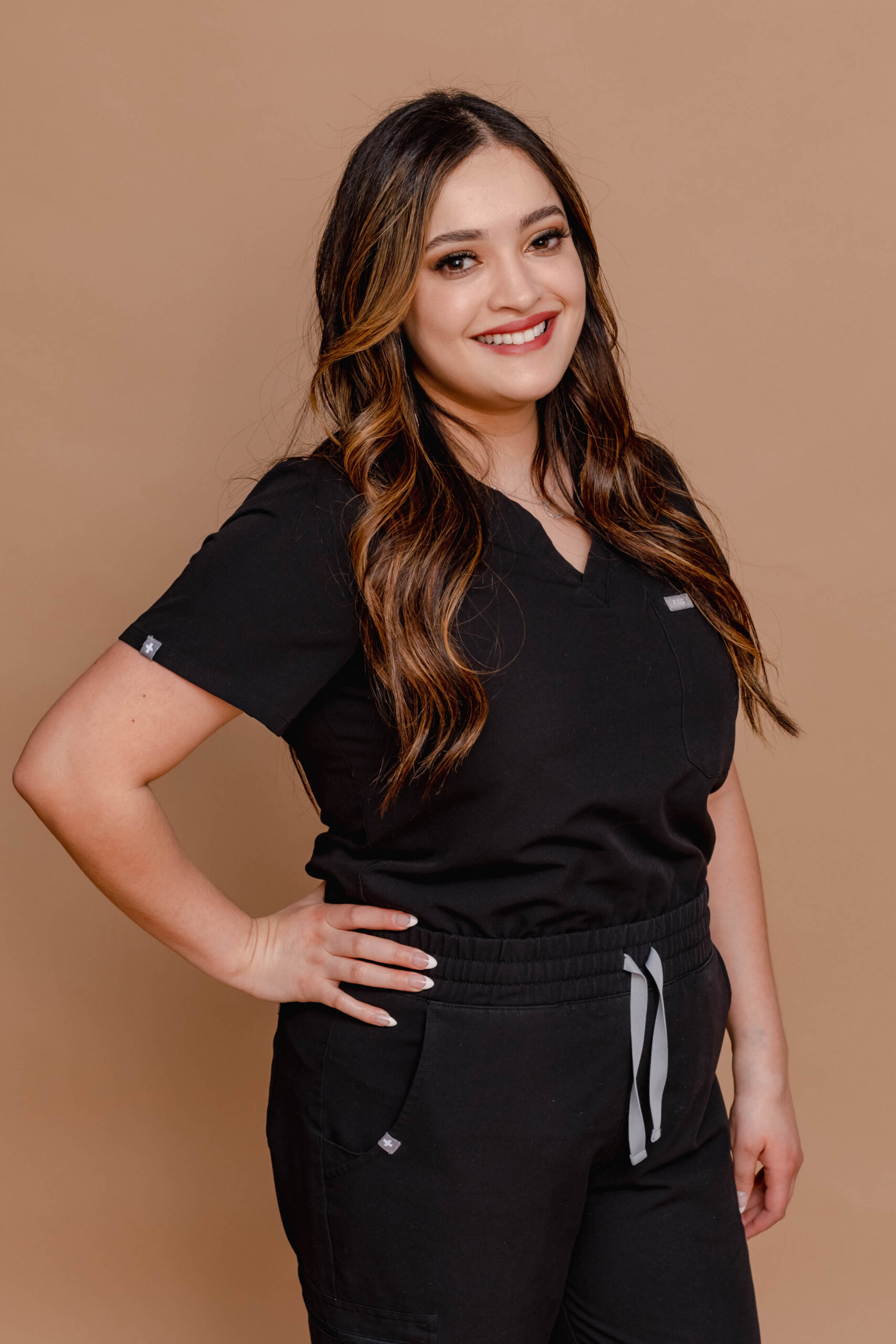 Emsculpt specialist at Belle Âme Med Spa in Oklahoma City holding the Emsculpt device used for muscle toning treatments.