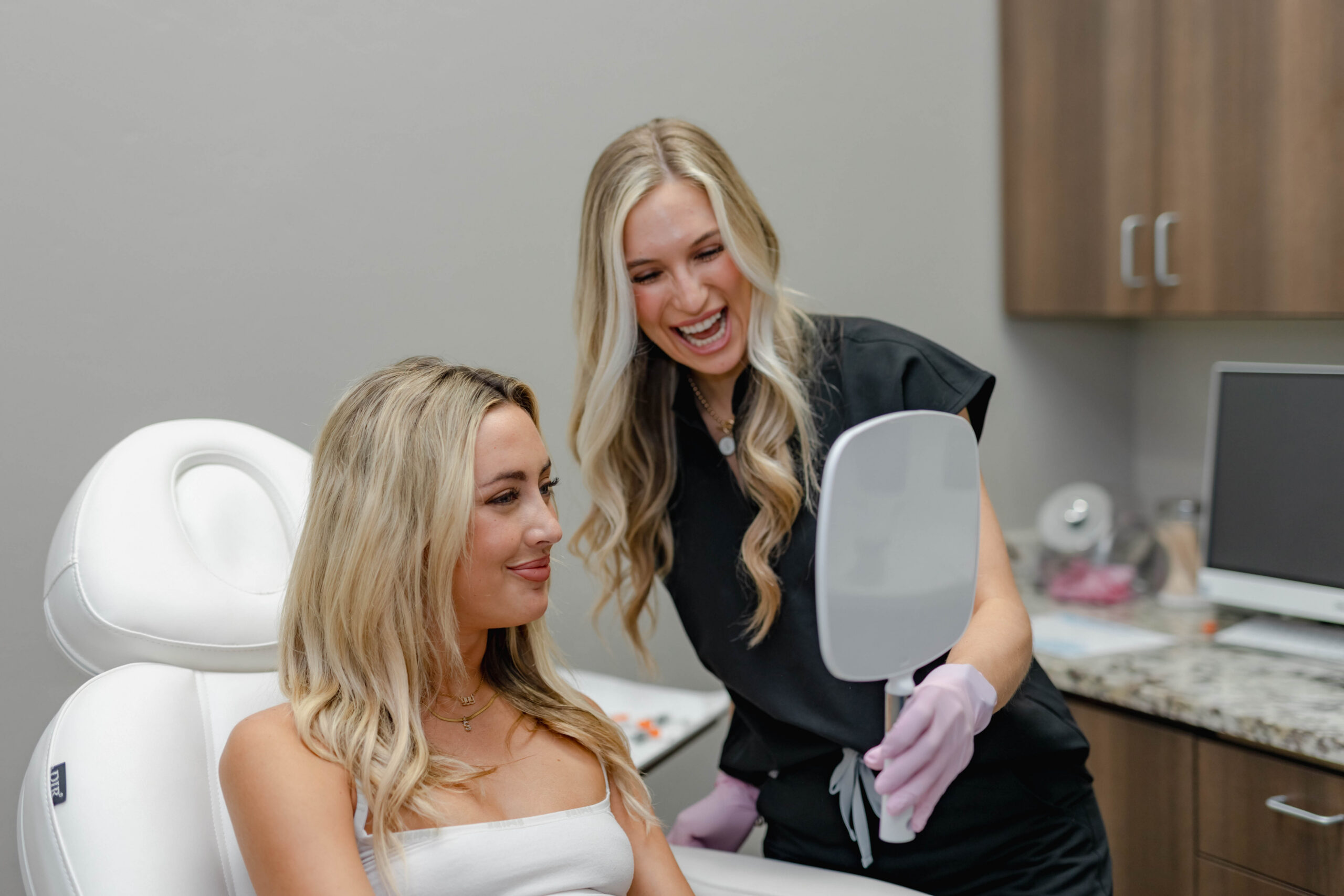 Patient and Belle Âme Med Spa provider reviewing results after personalized neurotoxins treatment for fine lines.