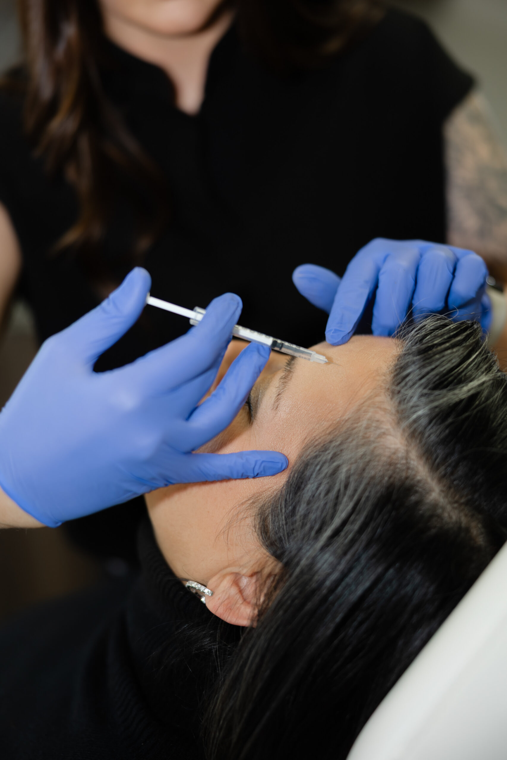 Injector administering neurotoxins to the forehead to soften fine lines at Belle Âme Med Spa in Oklahoma City.